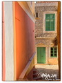 Orange wall and green windows in Yialos